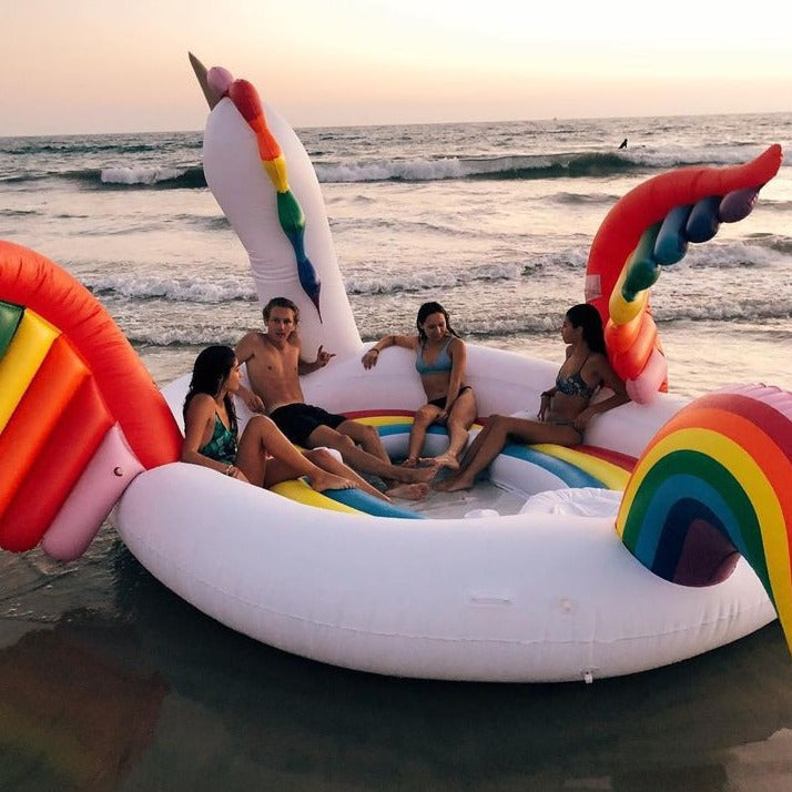 Pink flamingo pool raft with a built-in cup holder at every seat